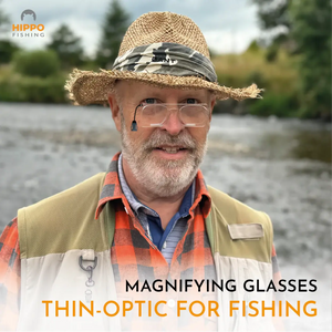 Fisherman wearing the 8270 quick-release fly fishing magnifier by the river