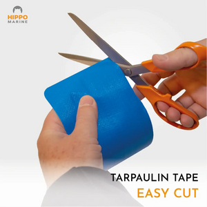 Heavy duty tarpaulin repair tape being cut with scissors to custom size for repairs.