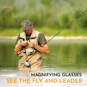 Fly fisherman using magnetic fly fishing magnifier with grey band to tie knots by the river.