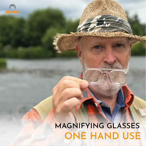 Magnetic fly fishing magnifier with grey band set up on fishing vest for quick one-hand access.