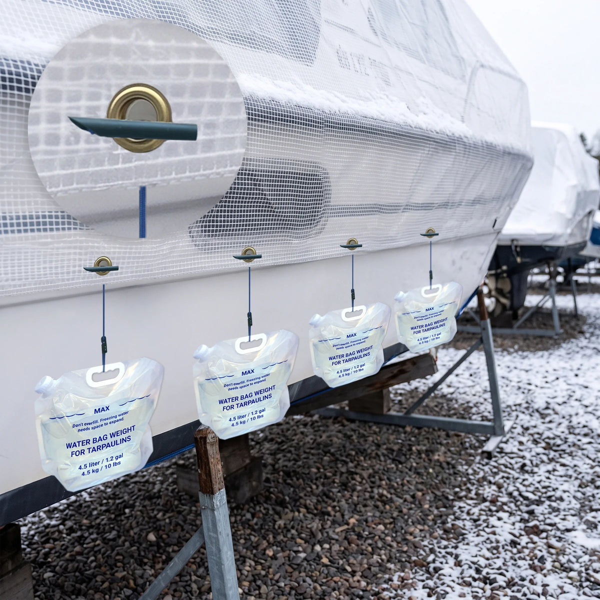 Clear boat tarp secured with 6620 bungee cords and water-filled tarp weights during winter storage.