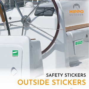 Green adhesive safety labels for toilets, doors, and emergency gear on boats.