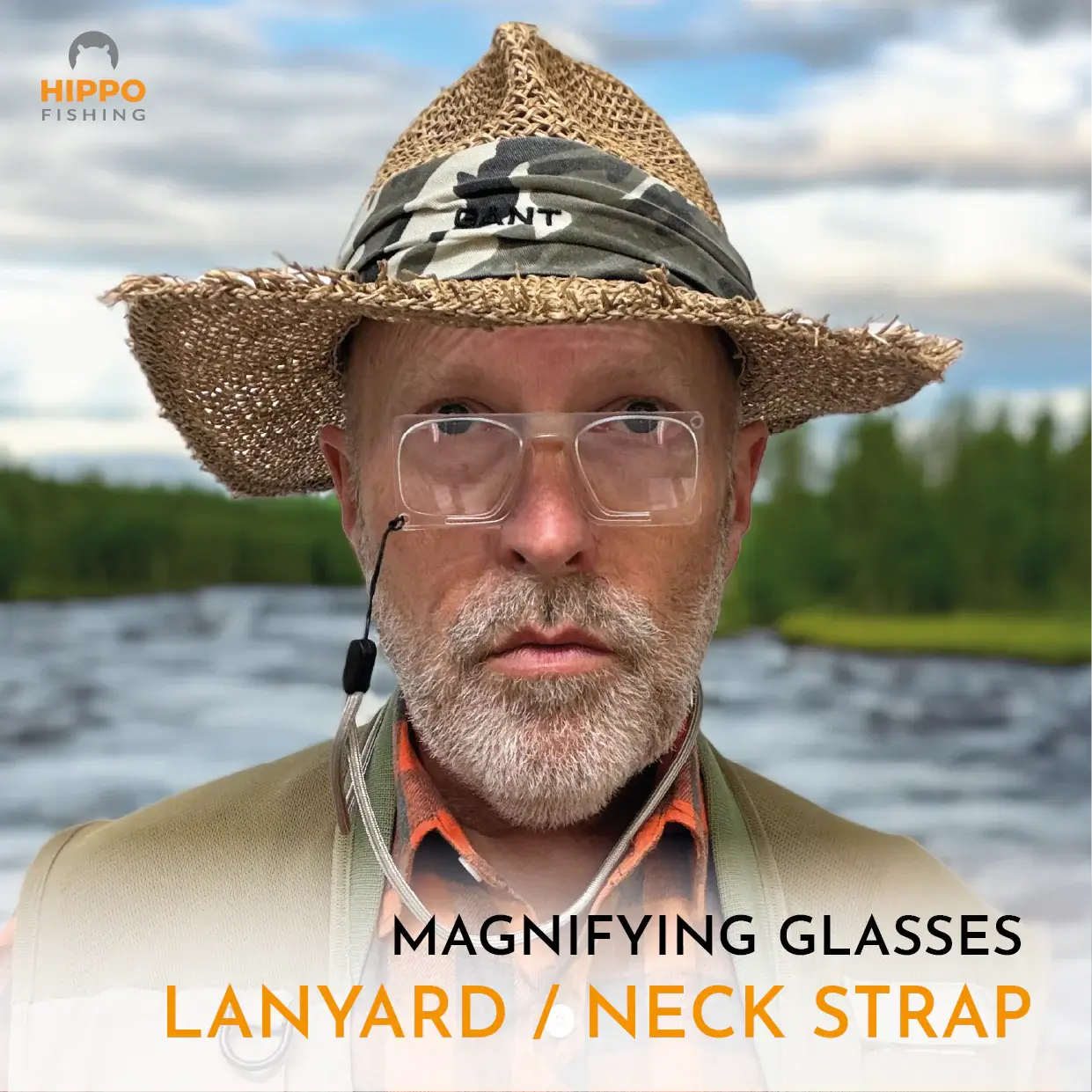 Angler wearing fly fishing magnifier with grey lanyard while inspecting small fly.