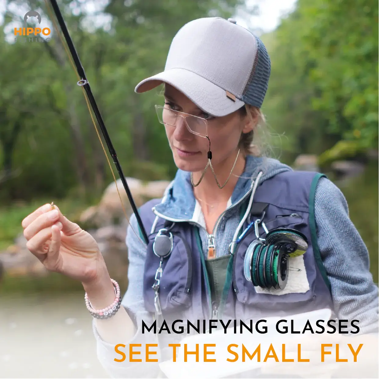 Angler using fly fishing magnifier grey lanyard 8279 for detailed fly tying and knot work in the field.