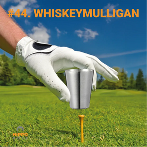 Golf glove holding a metal shot glass on a tee representing the Whiskey Mulligan golf rule 8190-09