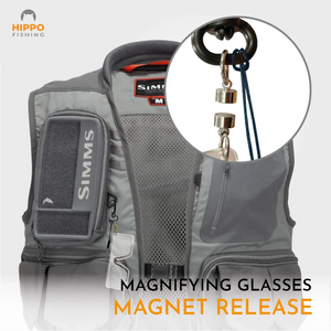 Magnetic fly fishing magnifier with grey band attached to fly fishing vest using strong magnet release.