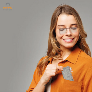 Woman wearing frameless pocket reading glasses and storing thin-optic case in shirt pocket.