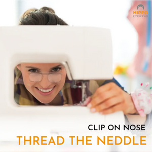 Woman threading a sewing machine needle using thin-optic clip-on nose magnifying glasses for detailed precision work